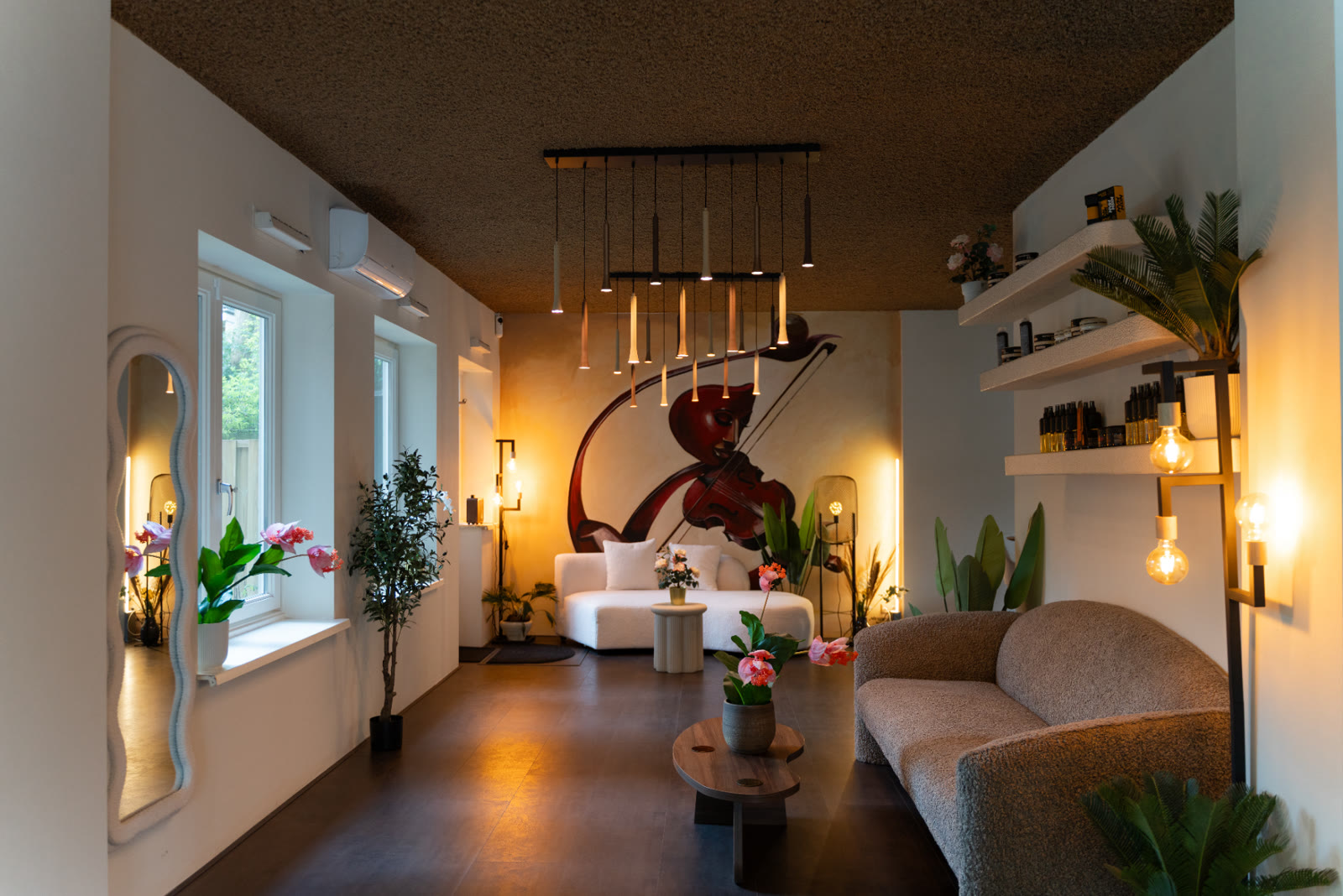 Warm lounge with couch, plants and wall art